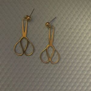 Unique gold tone earrings shaped like scissors